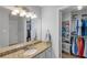Bathroom features a granite countertop and a well-organized closet with shelving at 6810-G Glenridge Dr, Atlanta, GA 30328