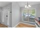 Cozy dining area with natural light from a window, light gray walls, and contemporary chandelier at 6810-G Glenridge Dr, Atlanta, GA 30328