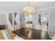 Open-concept dining area with wood floors, a staircase and view of the modern kitchen at 6810-G Glenridge Dr, Atlanta, GA 30328