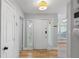 Bright entryway featuring hardwood floors, a white front door with sidelights, and a view into the adjacent living spaces at 6810-G Glenridge Dr, Atlanta, GA 30328