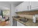 Kitchen featuring granite countertops, stainless steel dishwasher, and cabinets with stainless steel hardware at 6810-G Glenridge Dr, Atlanta, GA 30328
