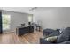 Open-concept living area with wood floors, neutral walls, and a large desk area at 6810-G Glenridge Dr, Atlanta, GA 30328