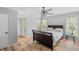 This bedroom boasts wood floors, a ceiling fan, and natural light from the large windows at 6810-G Glenridge Dr, Atlanta, GA 30328