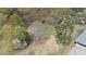 Aerial view of wooded acreage near a home, perfect for building or recreation at 6957 Mason Creek Rd, Douglasville, GA 30135