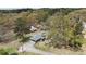 An aerial shot shows the home nestled in a serene landscape with mature trees and a long driveway at 6957 Mason Creek Rd, Douglasville, GA 30135