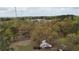 Aerial view showcasing the surrounding landscape, with ample trees and cell phone towers in the distance at 6957 Mason Creek Rd, Douglasville, GA 30135
