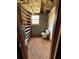 Basement bathroom with exposed ceiling, toilet, and shelving at 6957 Mason Creek Rd, Douglasville, GA 30135