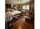 Bedroom features a bed, side table, and double hung windows at 6957 Mason Creek Rd, Douglasville, GA 30135