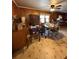 Dining room view highlighting wood paneling, tile floors, and a ceiling fan at 6957 Mason Creek Rd, Douglasville, GA 30135