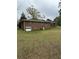 Rear view of a two-story brick home with a large yard at 6957 Mason Creek Rd, Douglasville, GA 30135