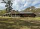 Charming single-story brick home with a cozy front porch and mature trees at 6957 Mason Creek Rd, Douglasville, GA 30135