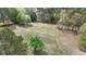 Large open lot surrounded by mature trees offering privacy and a serene natural setting at 6957 Mason Creek Rd, Douglasville, GA 30135