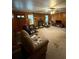Cozy living room with wood paneling, brick fireplace, and natural light at 6957 Mason Creek Rd, Douglasville, GA 30135
