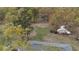 Aerial view of wooded lot with mature trees and home roof. A beautiful building site at 6957 Mason Creek Rd, Douglasville, GA 30135