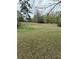 A large grassy yard with mature trees, offering space and natural beauty at 6957 Mason Creek Rd, Douglasville, GA 30135