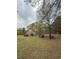 View of a spacious grassy yard with mature trees, offering a serene and natural setting at 6957 Mason Creek Rd, Douglasville, GA 30135