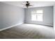 Spacious bedroom features neutral walls, carpeted floors, and a light-filled window at 1209 Richmond Rdg, Loganville, GA 30052