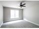Bright bedroom features neutral carpet, ceiling fan, one window, and light gray walls at 1209 Richmond Rdg, Loganville, GA 30052