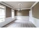 Elegant dining room features chair rail, neutral carpet, and a modern chandelier at 1209 Richmond Rdg, Loganville, GA 30052