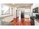Kitchen featuring hardwood floors, granite counters, with stairs and doorway visible at 1209 Richmond Rdg, Loganville, GA 30052