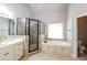 Main bathroom boasts a soaking tub, walk-in shower, double sink vanity, and tile floors at 1209 Richmond Rdg, Loganville, GA 30052
