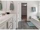 Bathroom featuring double sinks, a soaking tub, and a walk-in closet at 121 Shoals Bridge Rd, Acworth, GA 30102
