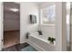 Bright bathroom with a soaking tub and walk in closet access at 121 Shoals Bridge Rd, Acworth, GA 30102