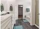 Bathroom with double sink vanity, garden tub, shower, and tile floors at 121 Shoals Bridge Rd, Acworth, GA 30102