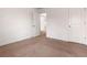 Neutral bedroom with carpeting, white walls, and a view into the hallway at 121 Shoals Bridge Rd, Acworth, GA 30102