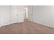 Neutral bedroom with carpeting, white walls, and two doors with a view into another room at 121 Shoals Bridge Rd, Acworth, GA 30102