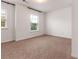 Neutral bedroom featuring two windows, neutral carpet, and white walls at 121 Shoals Bridge Rd, Acworth, GA 30102