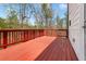 This home features a wooden deck with a classic railing and a view of the lush backyard at 121 Shoals Bridge Rd, Acworth, GA 30102