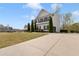 Long concrete driveway leading up to a two-story house with well-kept front yard at 121 Shoals Bridge Rd, Acworth, GA 30102