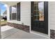 Close up of the front door with sidelight, featuring stone accents and fresh exterior paint at 121 Shoals Bridge Rd, Acworth, GA 30102