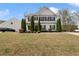 Charming two-story home with a well-manicured front lawn and tasteful landscaping with mature shrubbery at 121 Shoals Bridge Rd, Acworth, GA 30102