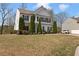 A well-maintained front lawn with manicured landscaping in front of a white two-story house at 121 Shoals Bridge Rd, Acworth, GA 30102