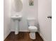 Half bathroom with pedestal sink, hardwood flooring and oval mirror at 121 Shoals Bridge Rd, Acworth, GA 30102