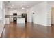 Open concept kitchen features white cabinets, stainless appliances, and hardwood flooring at 121 Shoals Bridge Rd, Acworth, GA 30102