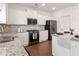 Well-equipped kitchen features granite counters, stainless appliances and white cabinets at 121 Shoals Bridge Rd, Acworth, GA 30102
