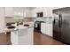 Bright kitchen with stainless steel refrigerator, granite counters and white cabinets at 121 Shoals Bridge Rd, Acworth, GA 30102