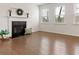 Cozy living room with hardwood flooring, fireplace, and bright natural light at 121 Shoals Bridge Rd, Acworth, GA 30102