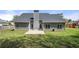 View of the back of the home featuring neutral siding, a gray roof, and a concrete patio at 2232 Ann Ln, Lithia Springs, GA 30122