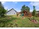 Spacious backyard with a wooden playset and a fenced-in yard perfect for outdoor activities and Gathering fun at 2232 Ann Ln, Lithia Springs, GA 30122