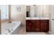 Bathroom boasts double vanity, separate tub, and neutral tile at 2232 Ann Ln, Lithia Springs, GA 30122