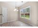 Cozy breakfast nook offers a large window and an elegant chandelier at 2232 Ann Ln, Lithia Springs, GA 30122
