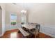 Bright and airy dining room featuring beautiful hardwood floors and large windows for natural light at 2232 Ann Ln, Lithia Springs, GA 30122