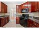 Kitchen features black appliances, granite countertops, and tiled backsplash at 2232 Ann Ln, Lithia Springs, GA 30122