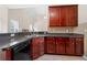 Kitchen with dark wood cabinets, granite counters, and stainless-steel sink at 2232 Ann Ln, Lithia Springs, GA 30122