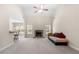 Inviting living room featuring a stone fireplace, carpeted floors, and views into the kitchen at 2232 Ann Ln, Lithia Springs, GA 30122