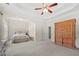 Large primary suite with tray ceiling, neutral carpet, natural lighting, and en-suite bath at 2232 Ann Ln, Lithia Springs, GA 30122